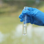 Hand holding a glass beaker