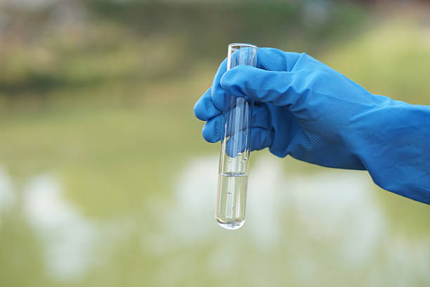 Hand holding a glass beaker