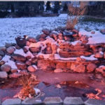 Pond and waterfall with snow and ice