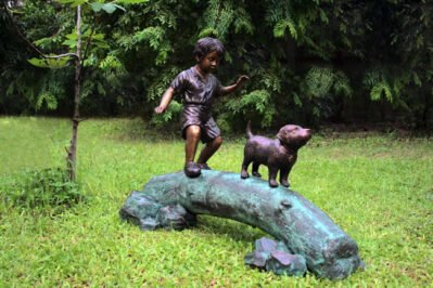 Boy Following Dog Across Log